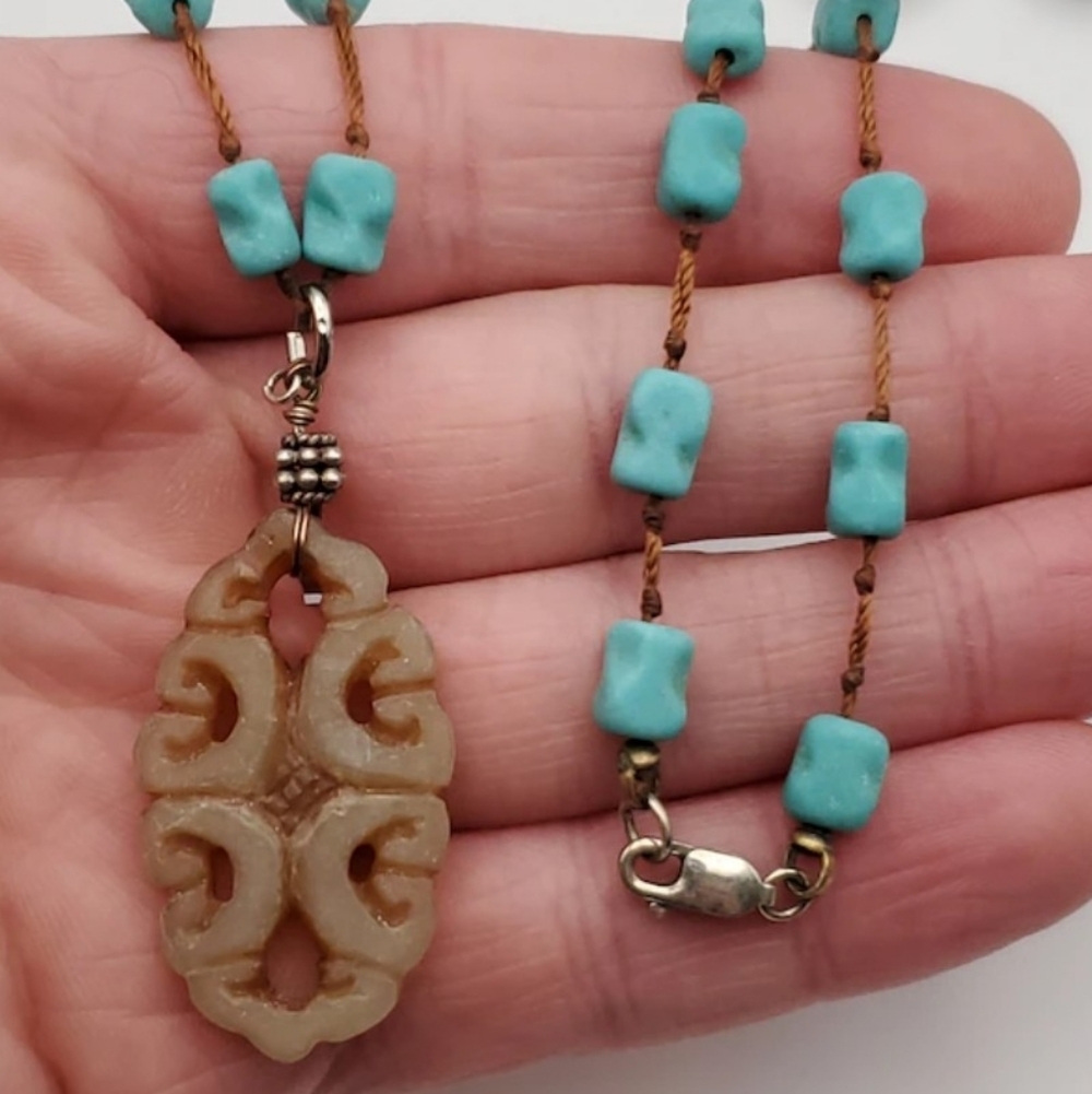 Necklace featuring turquoise nugget beads wth silver clasp.